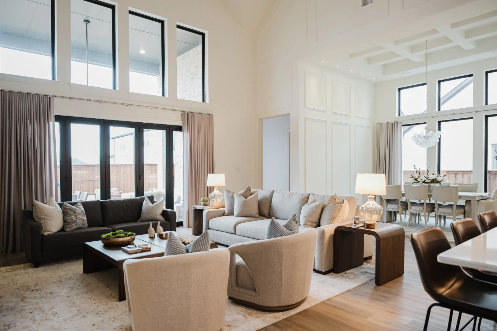 Double-height living room with custom wall molding and a floor-to-ceiling feature wall