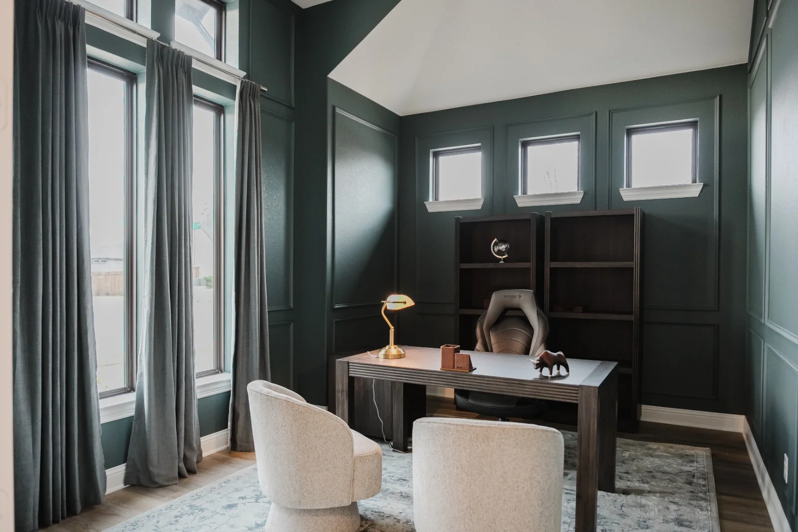 Deep green home office with picture-frame wall molding