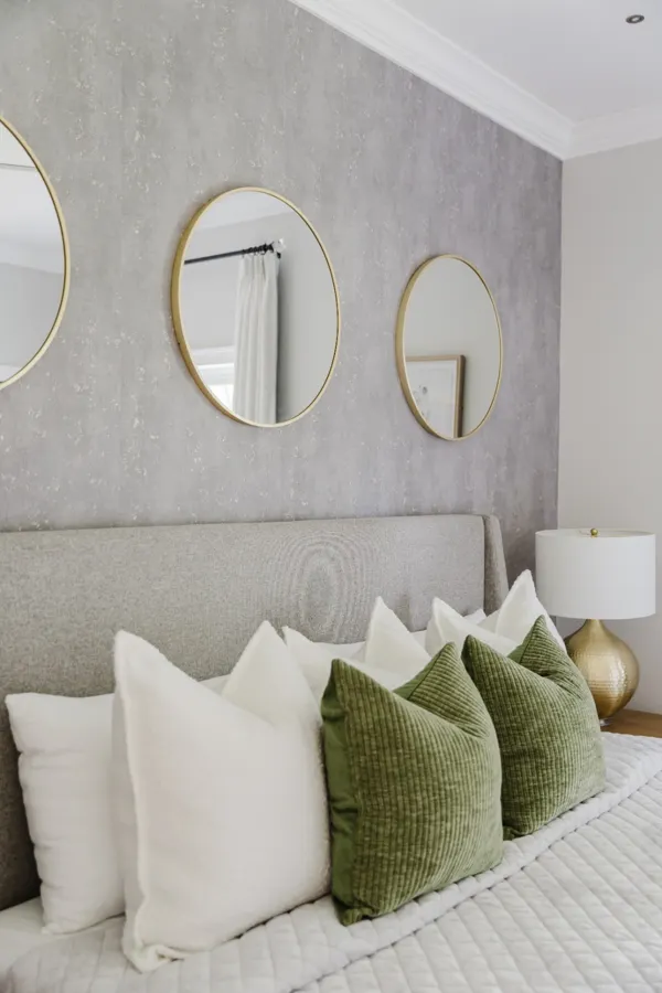 Textured bedroom with round mirrors
